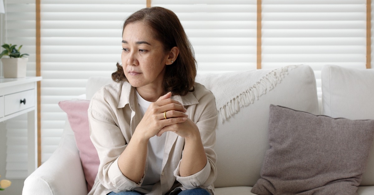 mom sitting on the sofa looking worried