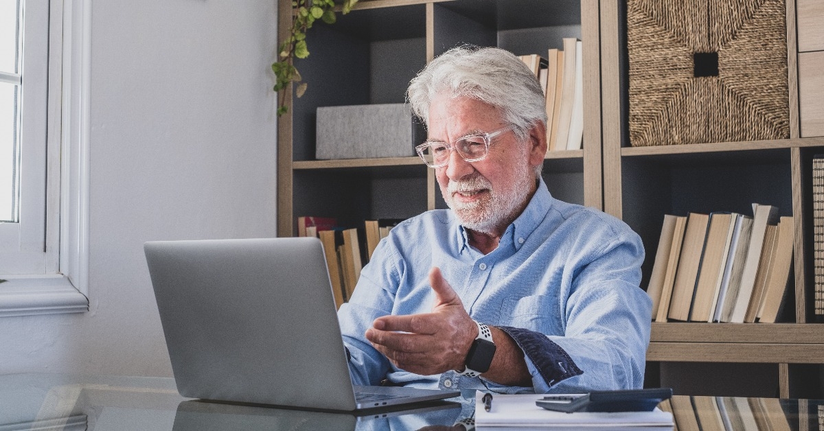 old caucasian businessman smiling working online watching webinar 