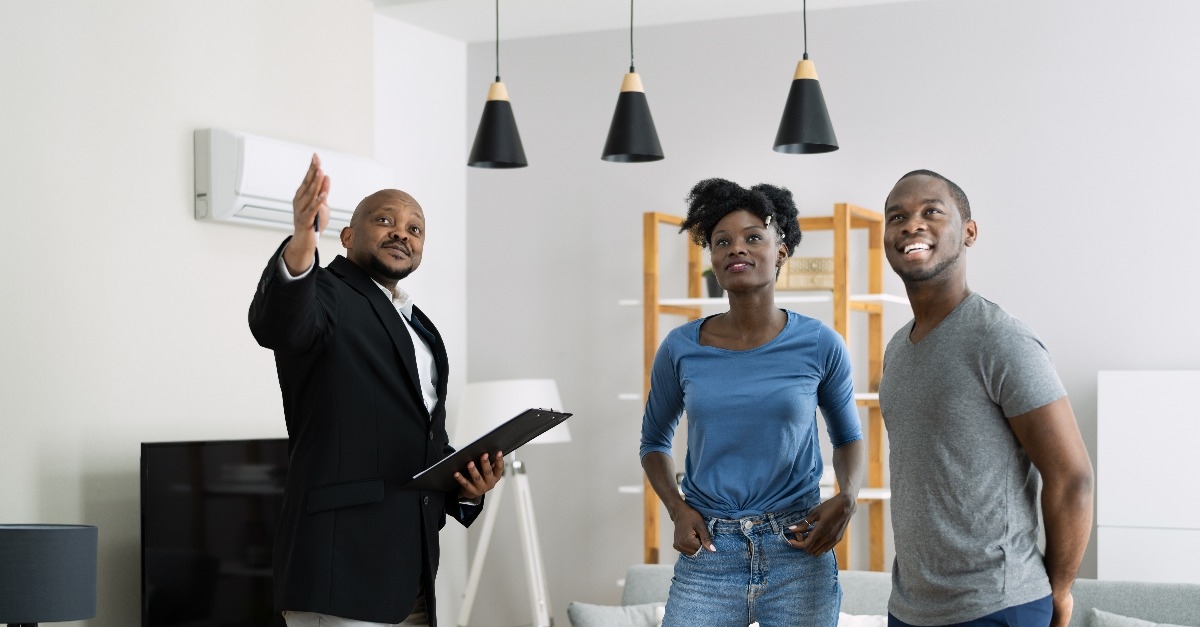 agent showing new real estate to couple
