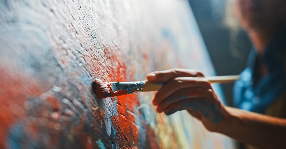 female artist works on abstract oil painting 