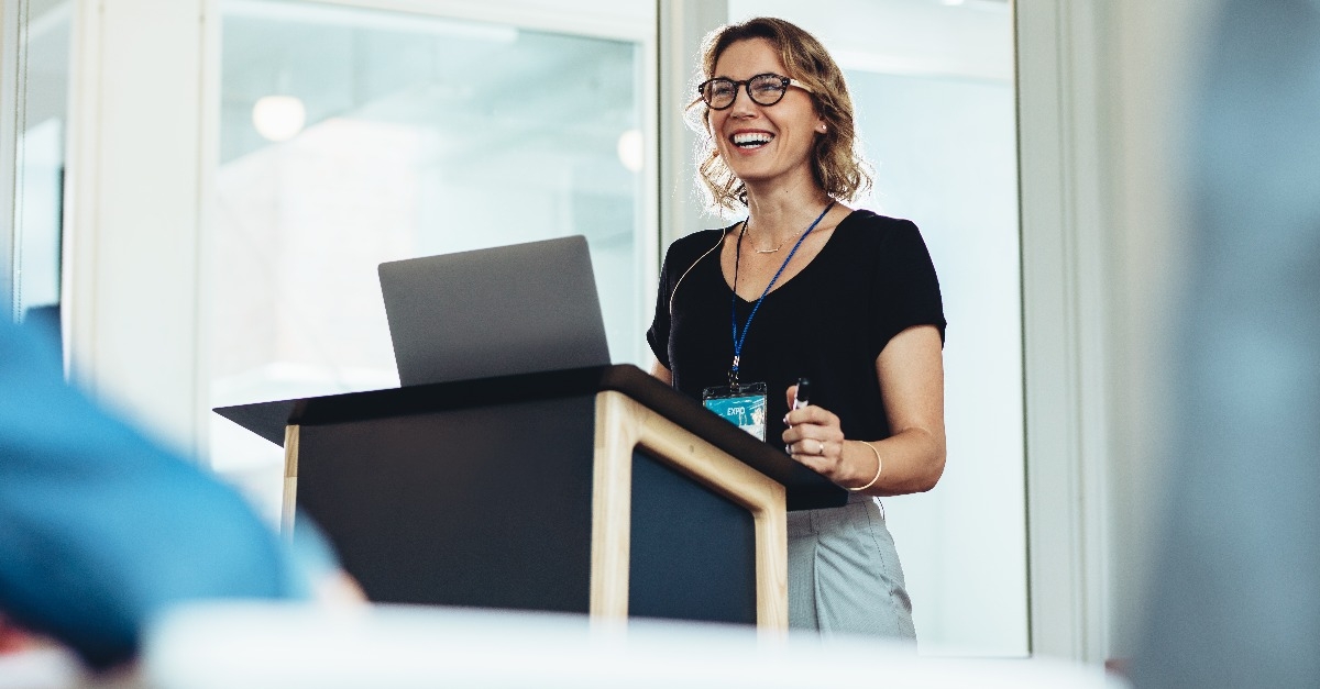 female business professional addressing a seminar 
