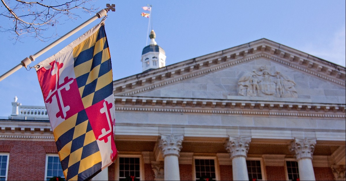 Maryland state flag in front of the capitol state house in Annapolis
