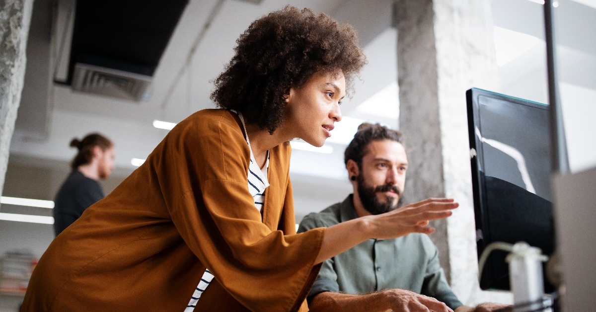 programmers cooperating at IT company developing apps 