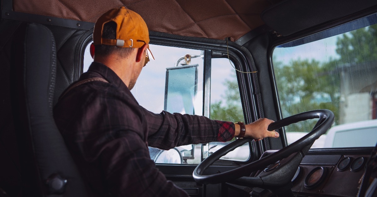 trucker driving a vintage aged semi truck