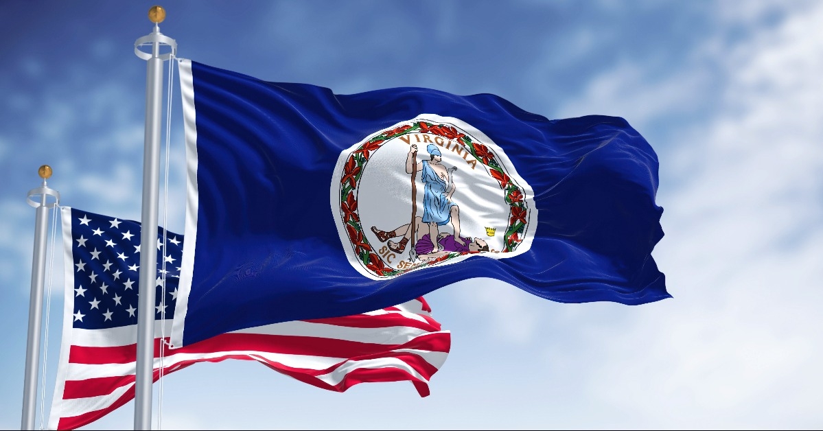 Virginia state flag waving along with the national flag of the United States of America