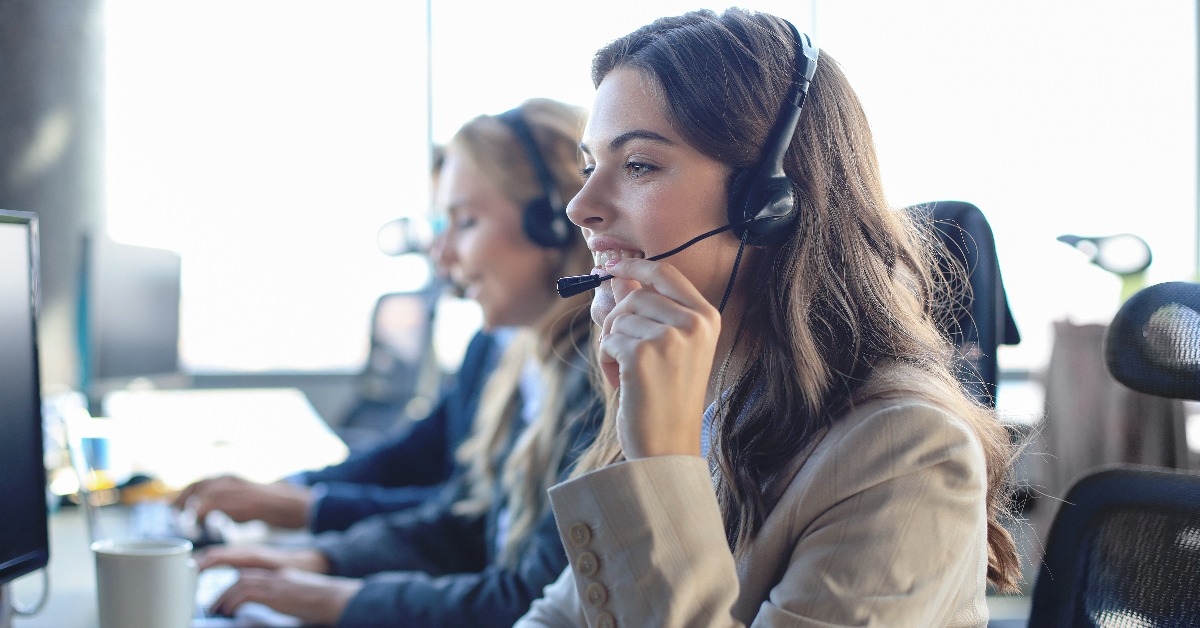 female customer support operator with headset and smiling