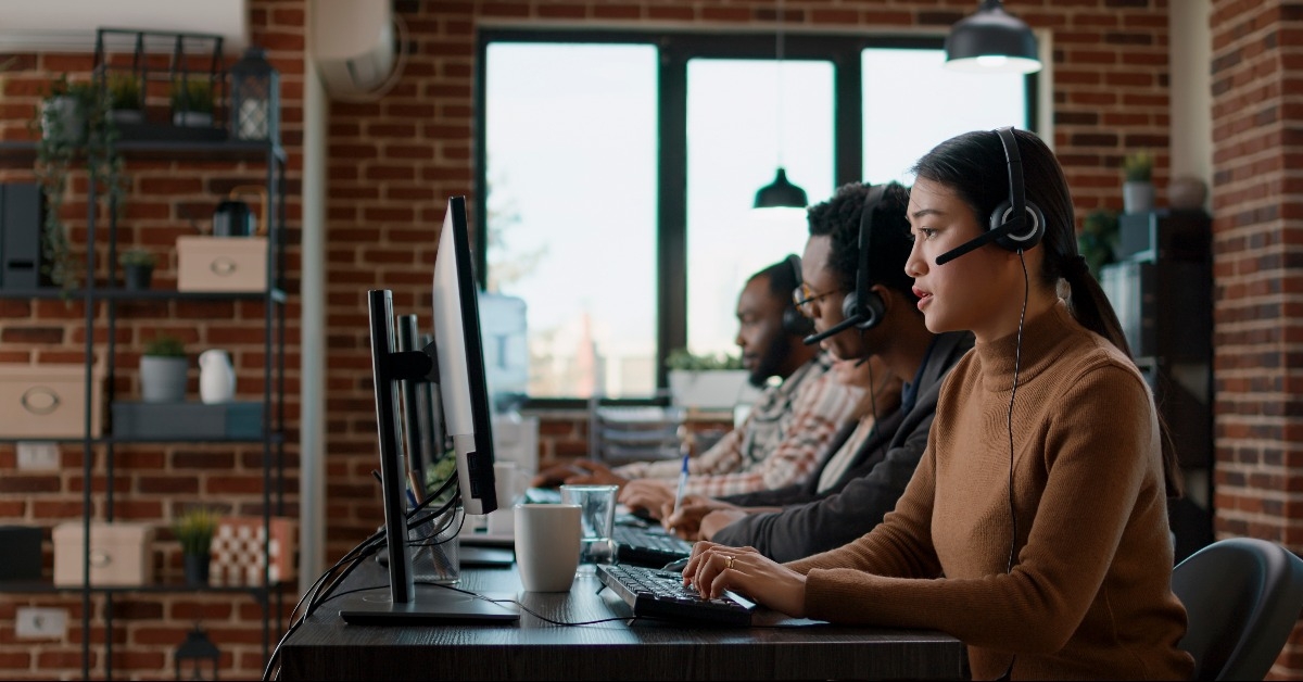 Company employees offering assistance and support to people at customer care service