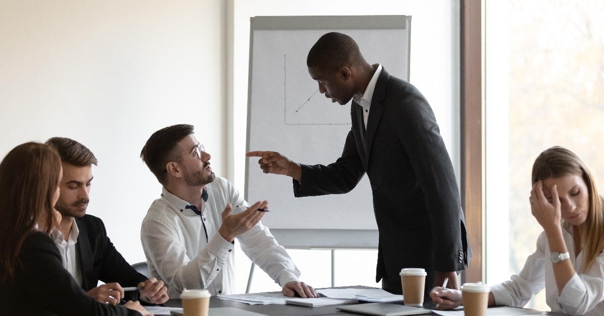 businessmen having conflict accusing each other during meeting