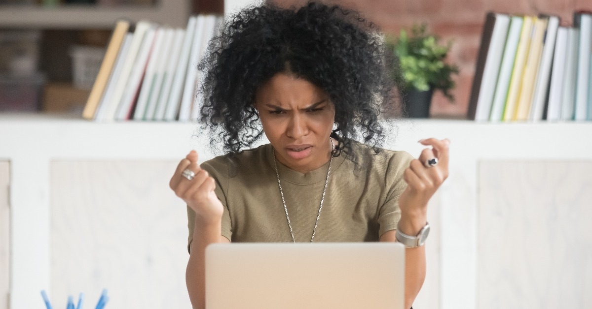 mad black female having laptop working problem