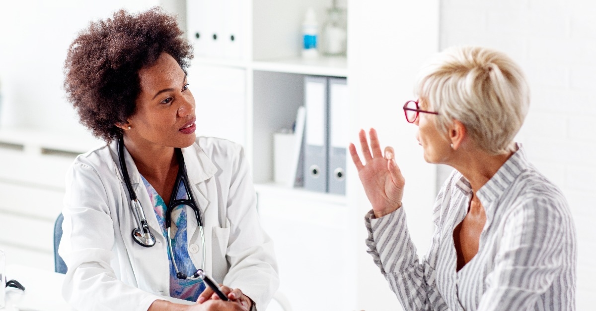 mature woman talk with her doctor about health in clinic