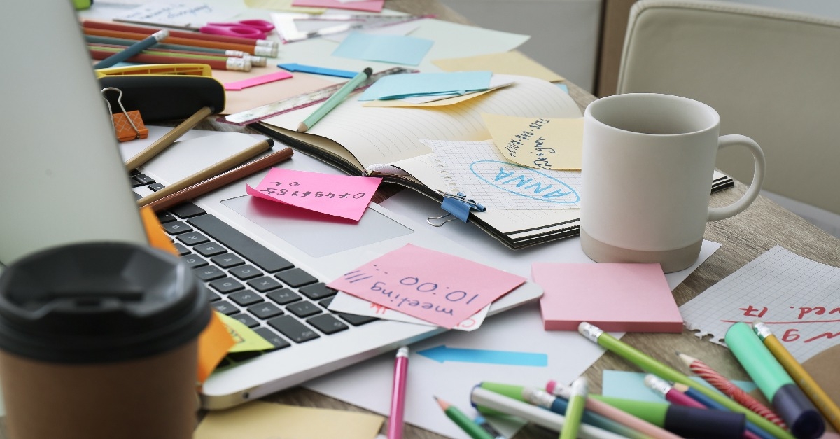 notes and office stationery in mess on desk