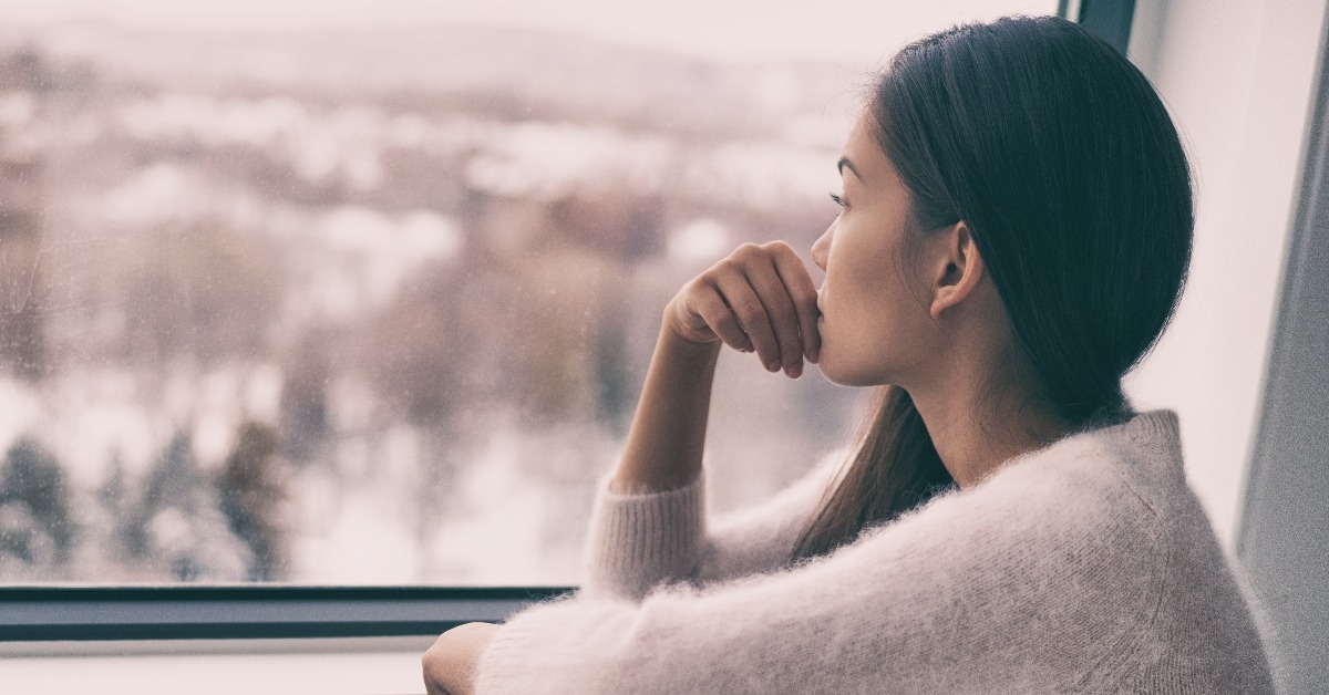 woman looking out the window 