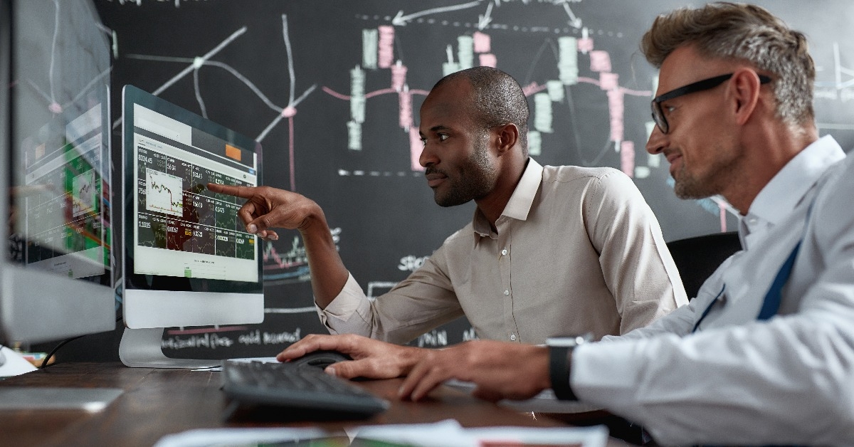 two diverse colleagues traders discussing ideas 