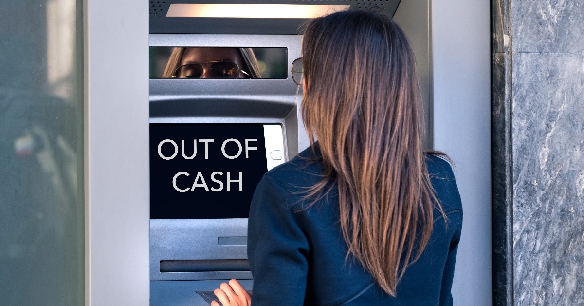 woman tries to take cash money from an ATM machine