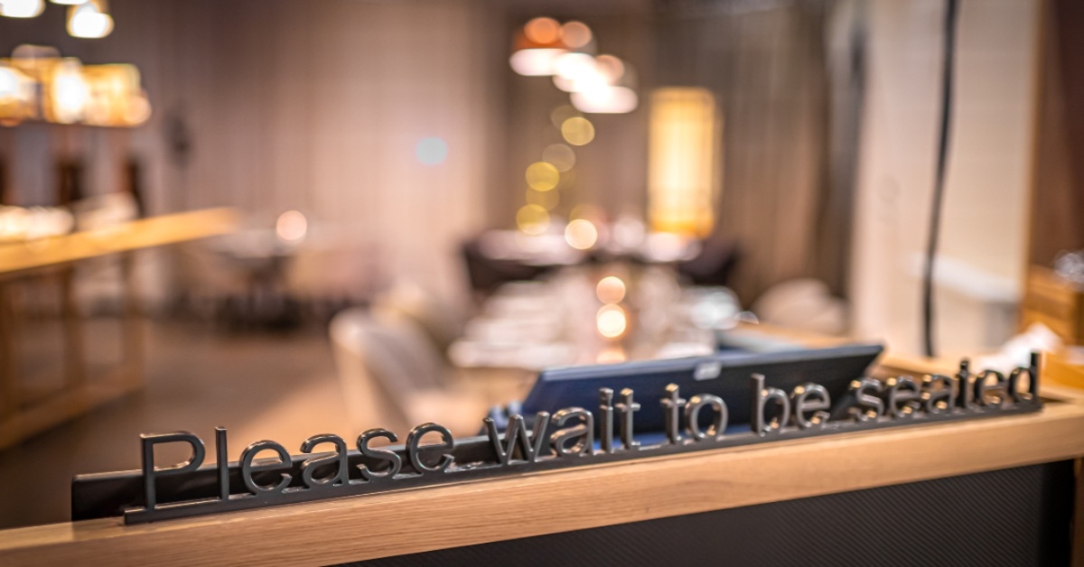 Wait to be seated sign at the restaurant