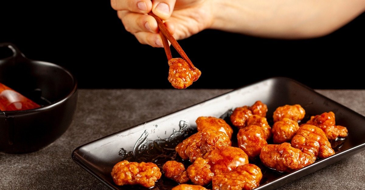 eating delicious mandarin orange chicken 