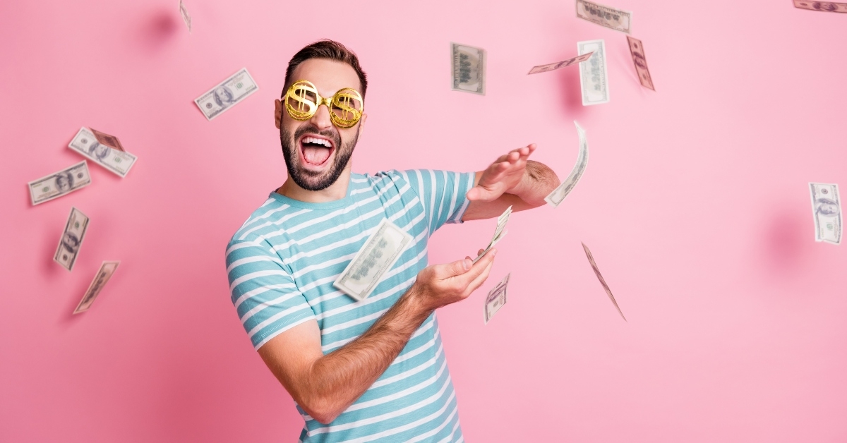 man with dollar-sign glasses throwing money