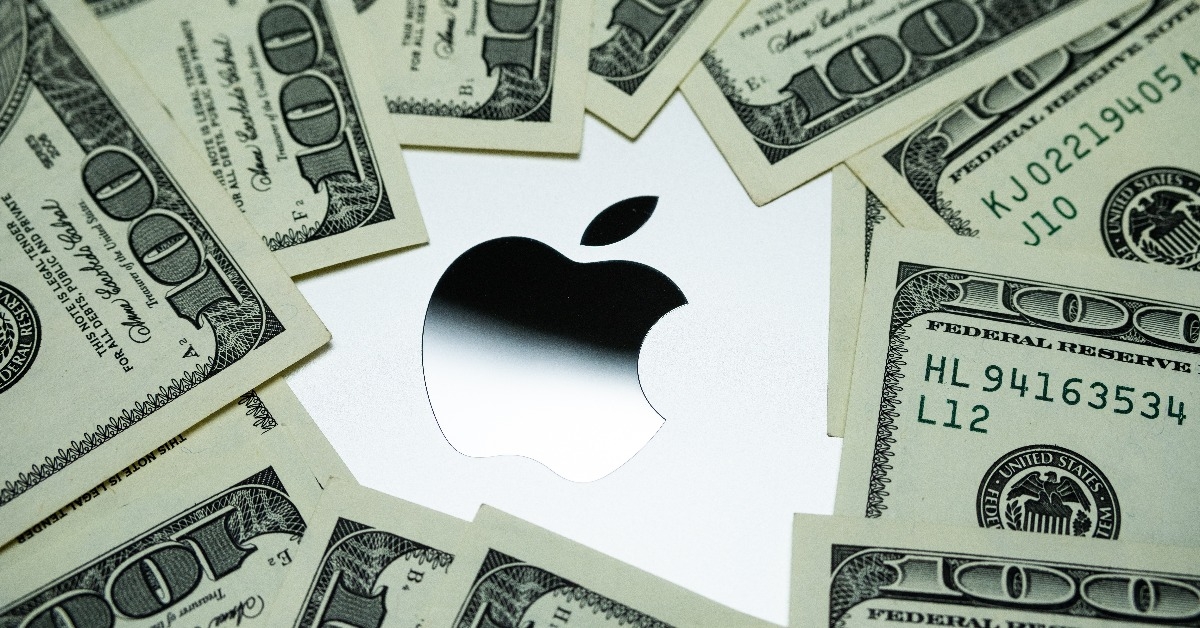 Apple logo surrounded by US dollar banknotes