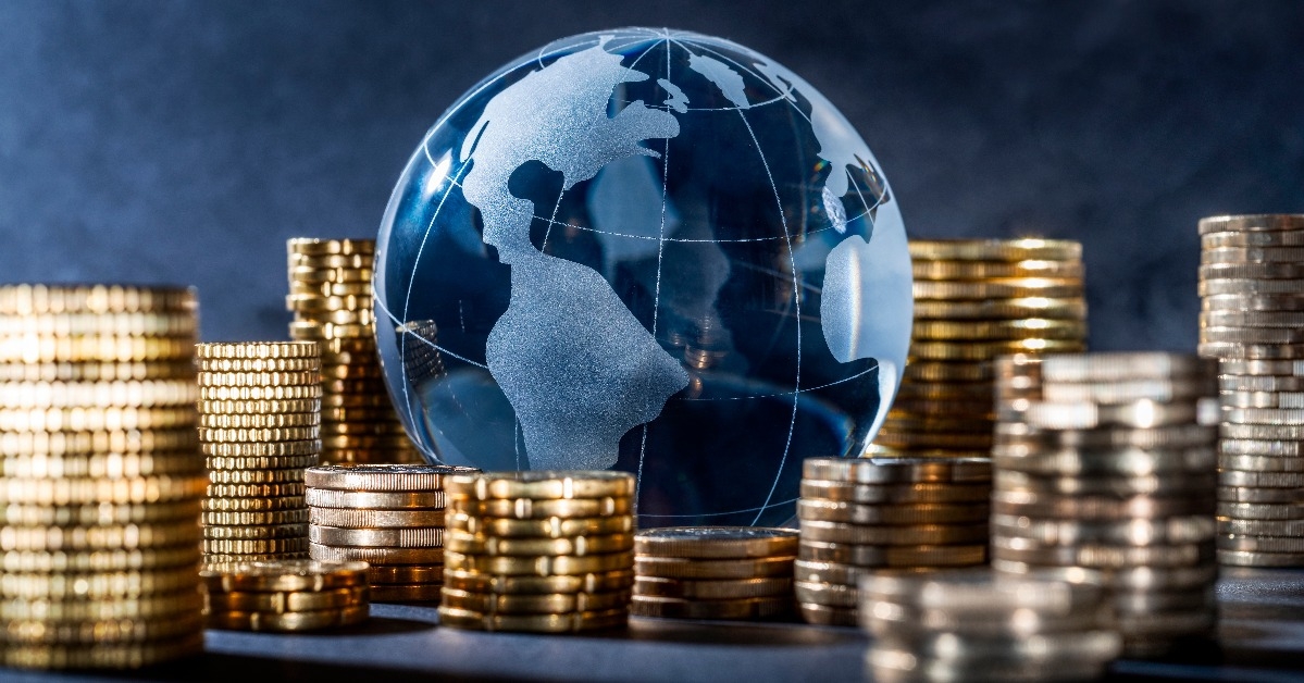 globe and stack with coins