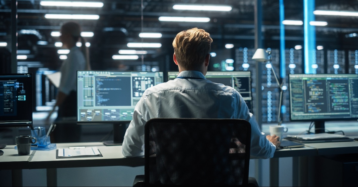 system administrator saves backup data in dark evening room 