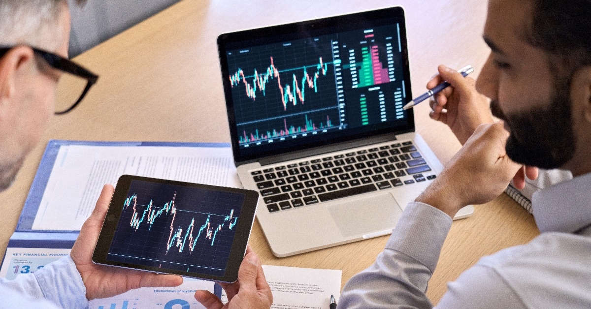 two diverse traders discussing crypto chart 