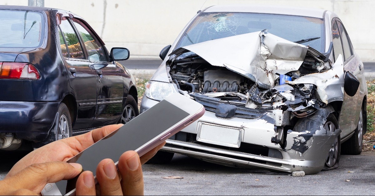 car insurance agent take pictures of accident-damaged vehicles
