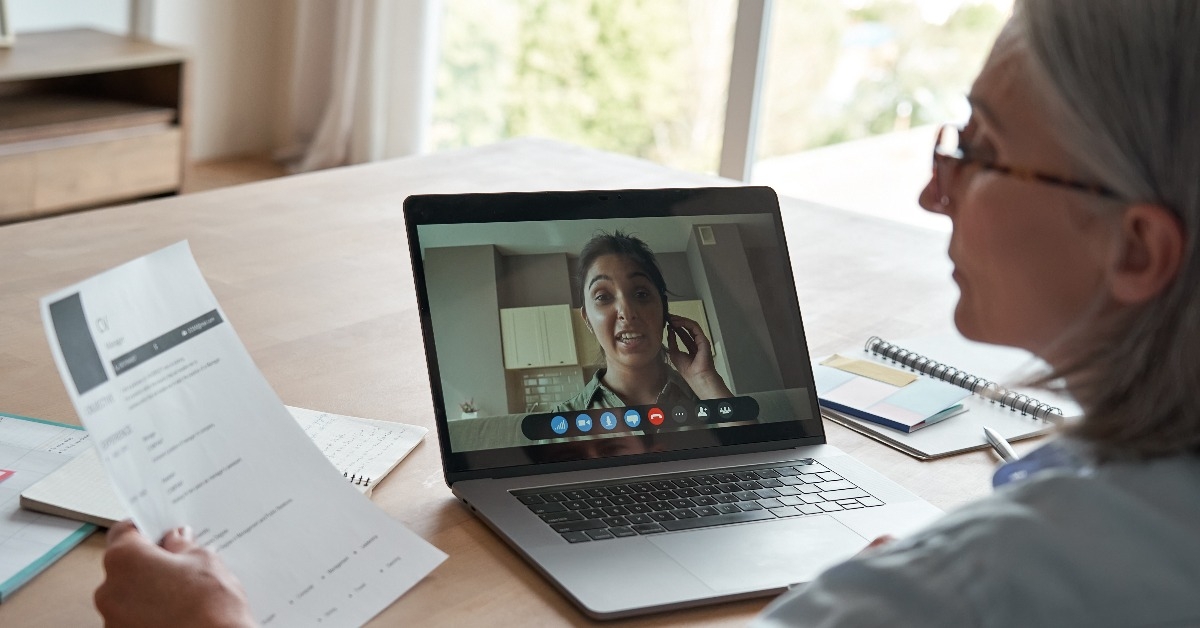 female hr reading cv during online job interview by video call