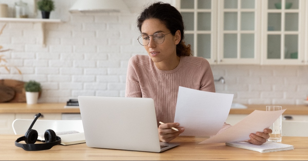 woman holding financial documents 