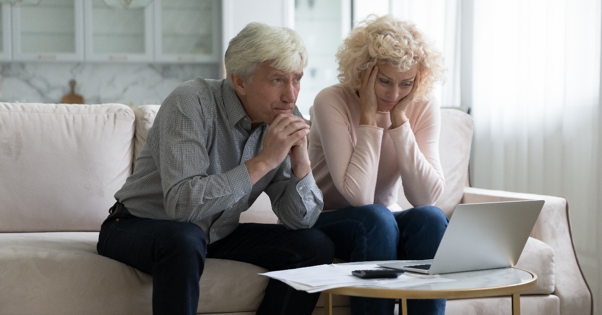 mature husband and wife frustrated about overspending family budget 