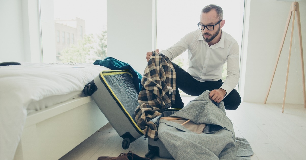 man packing clothes 
