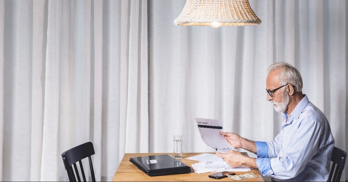 pensioner calculates the pension and bills lamp
