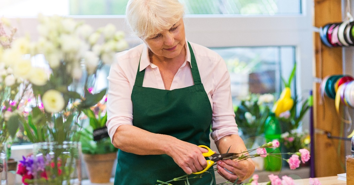 senior woman working in florist shop 