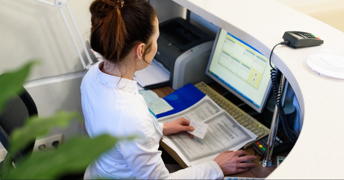 female receptionist working the computer
