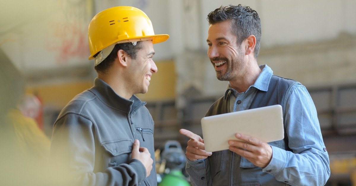 workers talking and laughing at a factory