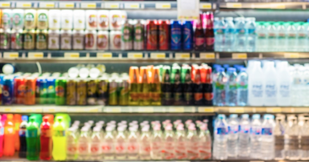 supermarket shelves with bottles of beverages