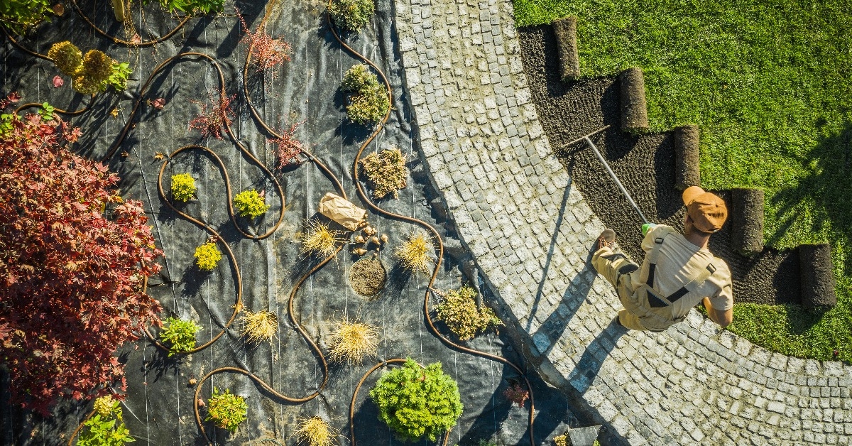 landscape specialist finishing newly developed garden