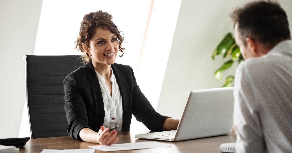  smiling businesswoman talking to a client