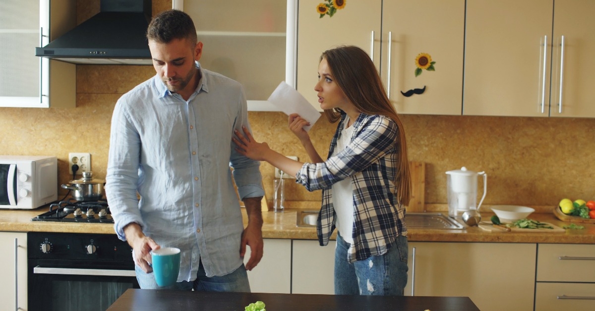 young couple quarrels in the kitchen at home