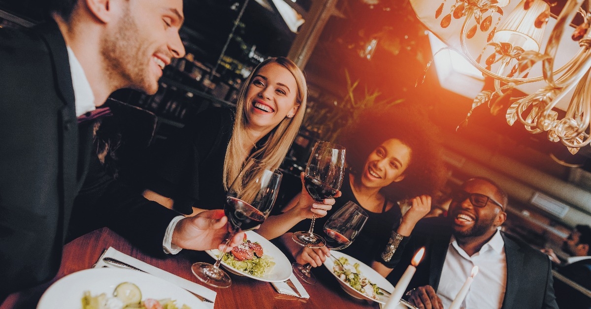 friends chilling out enjoying meal in restaurant