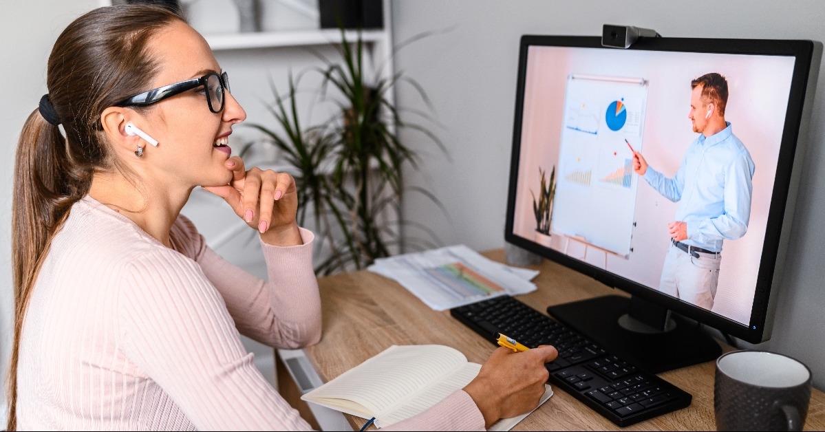 woman in office is watching online class