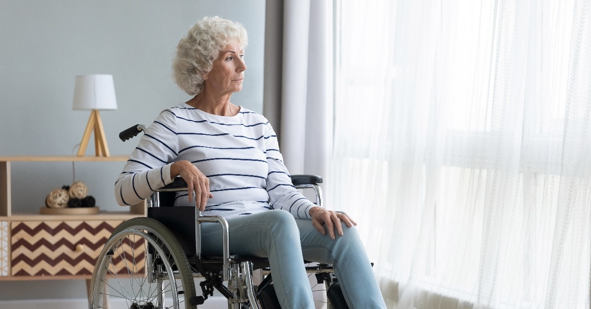upset disabled older woman sitting in wheelchair