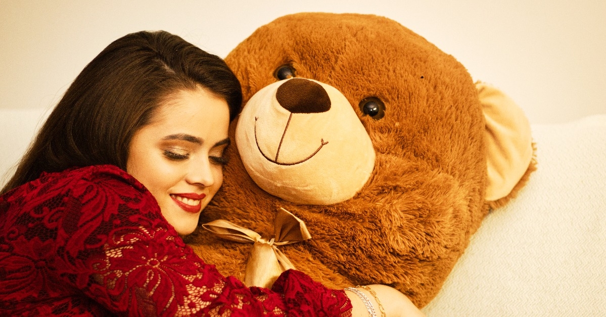 woman hugs big giant bear 