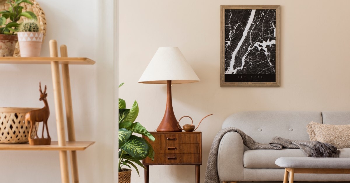 a living area with grey sofa, stylish furniture and art on the wall