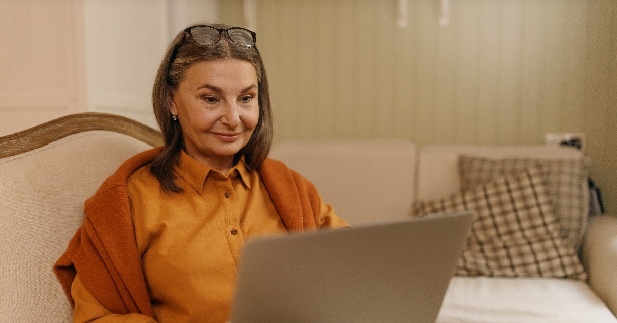 confident female on retirement sitting on comfortable armchair