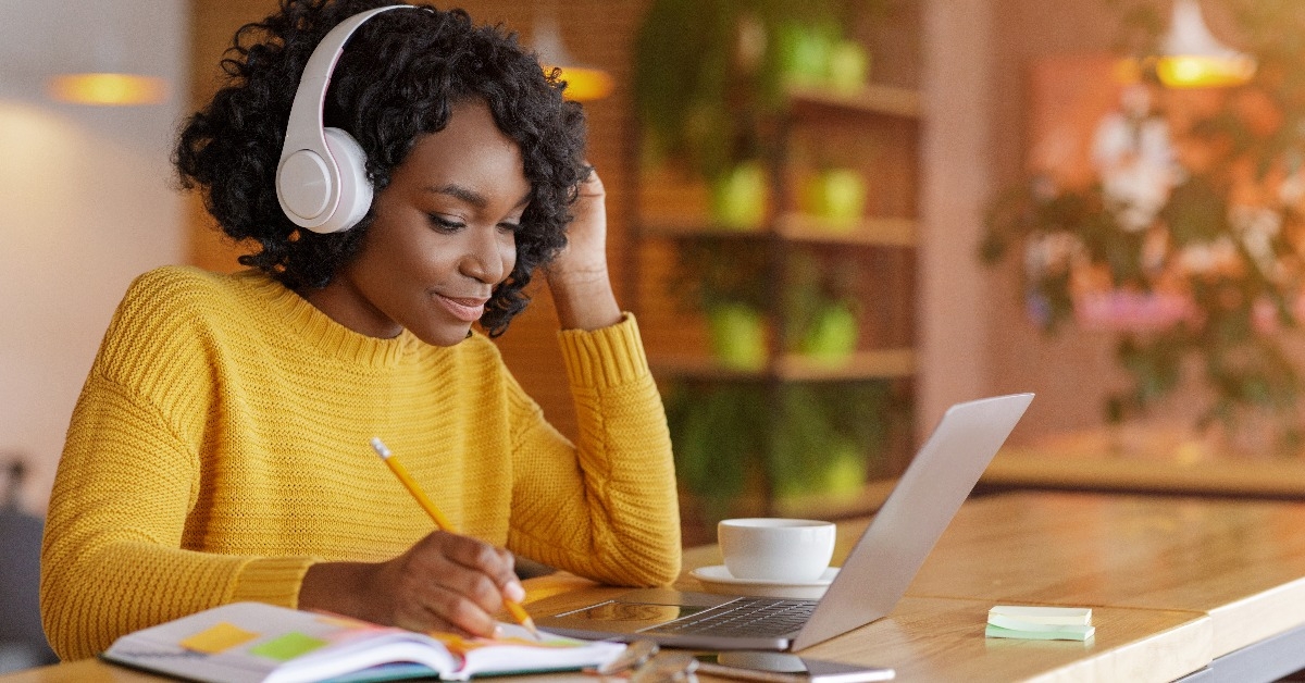 young woman with headset studying online