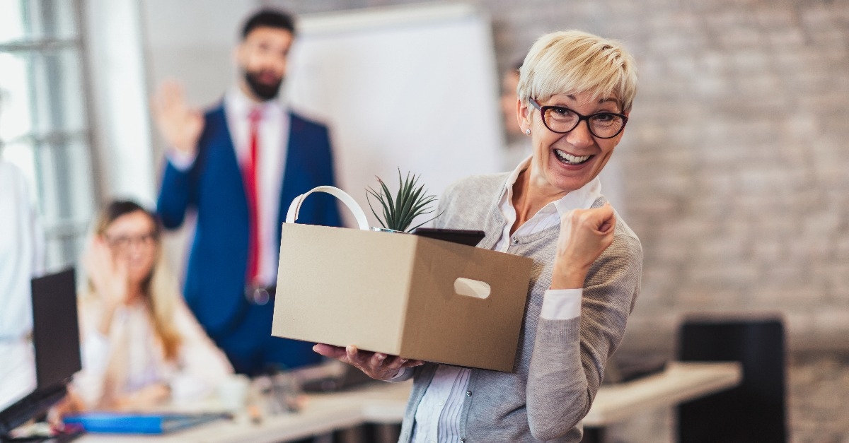 employee leaving office with box full of belongings