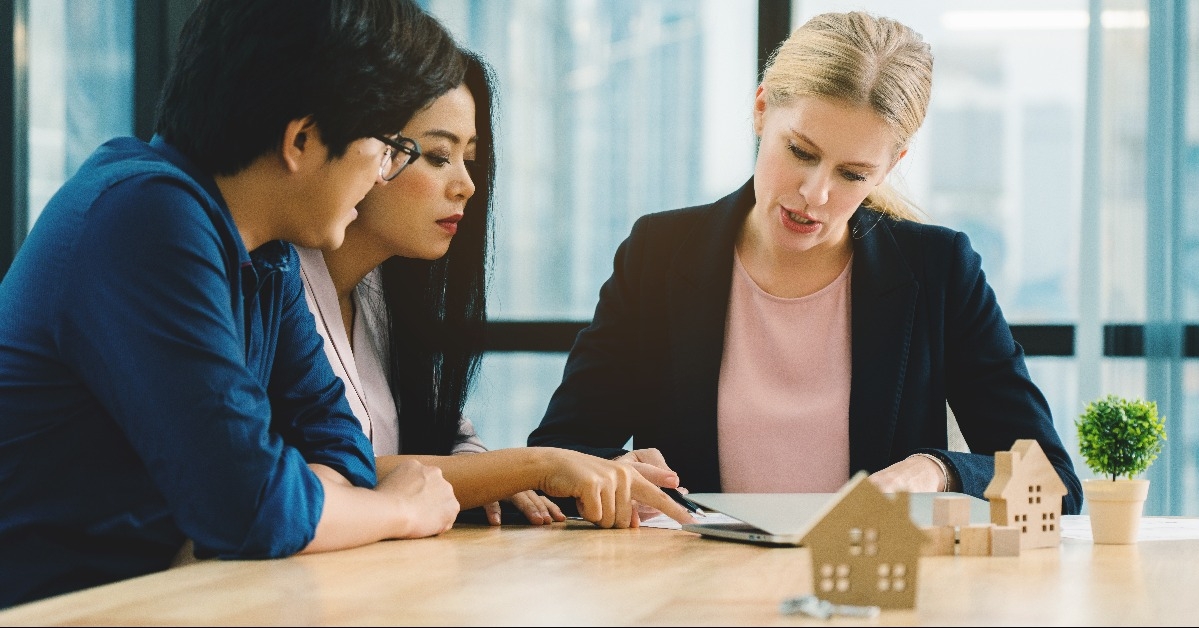 financial agent advising asian family to buy a home