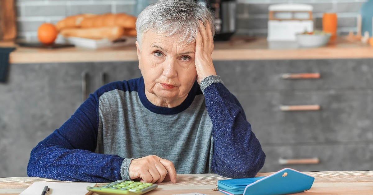 senior woman counting money at home
