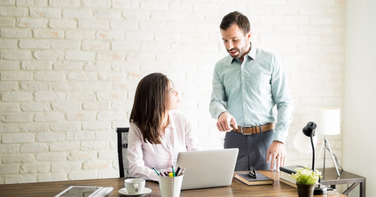 boss explaining something to a female employee 