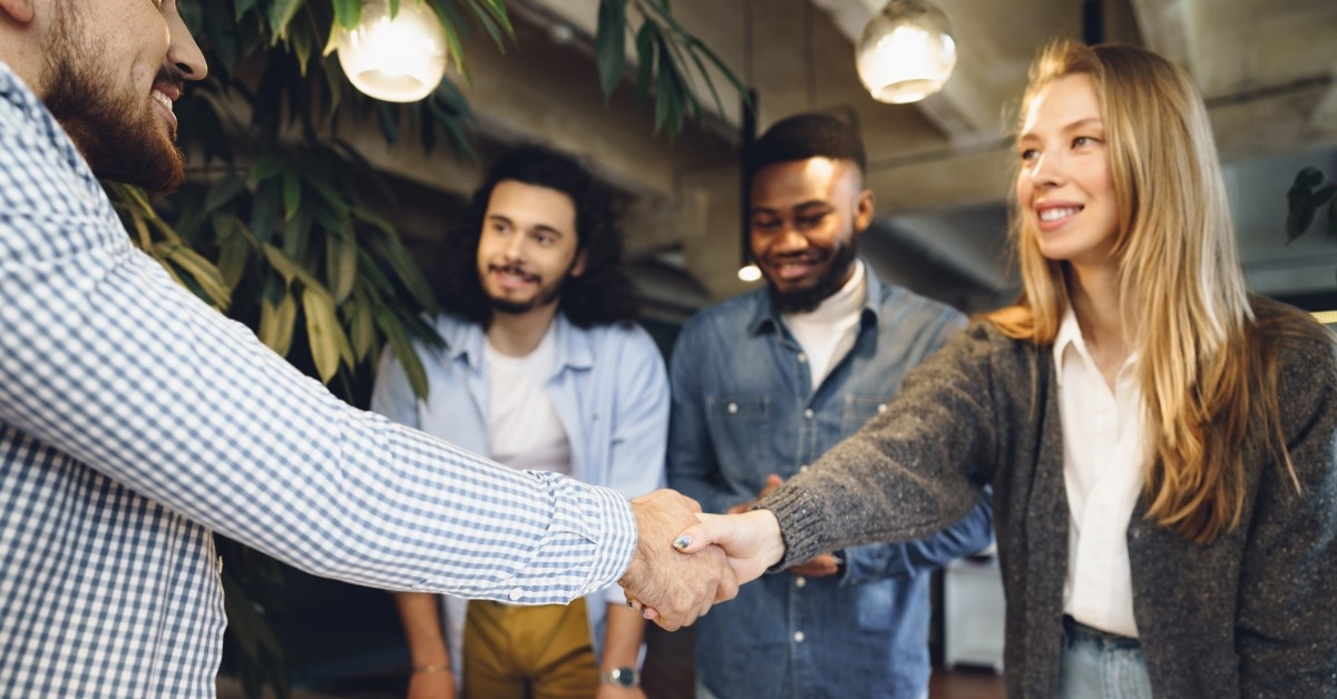 young woman shaking hand with a new employee